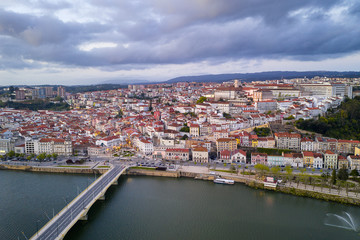 Fototapeta premium Coimbra drone aerial city view at sunset with Mondego river and beautiful historic buildings, in Portugal