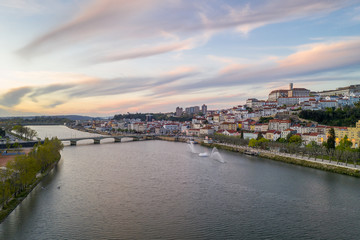 Fototapeta na wymiar Coimbra drone aerial city view at sunset with Mondego river and beautiful historic buildings, in Portugal