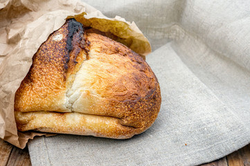 Fresh white wheat bread in the assortment of home-made sourdough. Bread made from wheat grains on a wooden Board. Copy of the space