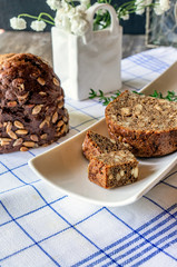 Fresh bread in the assortment of home-made sourdough. Bread with wheat grains and seeds on a wooden Board. Close up