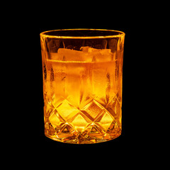 Close-up of glass with whiskey on black background.