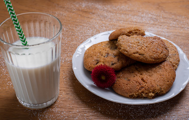 caramel dulce de leche biscuits with glass of milk on wooden table 