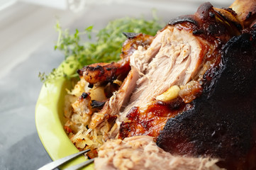 a piece of fried pork knuckle with a side dish of sauerkraut. national Czech and German meat dish.