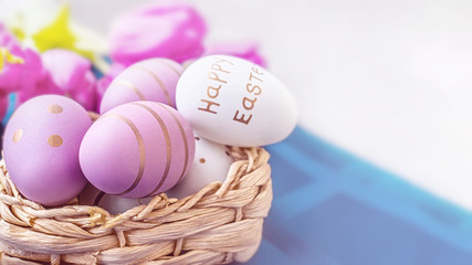 Colorful Easter eggs in a basket on the table. Festive decor for Easter