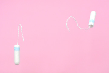 Medical female flyeng tampon on a pink background. Hygienic white tampon for women.Tampons on a pink background