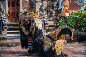 Traditional Barong dance with funny face mask and colourful dress to mimic hindu character from Ramayana during the morning in Bali