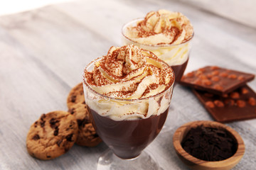 hot chocolate with cocoa and chocolate chip cookies and whipped cream