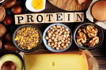 healthy eating and diet concept, natural rich in protein food on rustic table with wooden letter protein