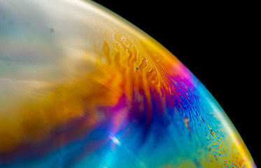 Psychedelic abstract planet from soap bubble, Light refraction on a soap bubble, Macro Close Up in...