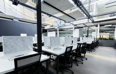 Light modern open space office with computers, no people