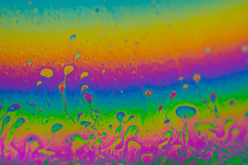 Psychedelic abstract planet from soap bubble, Light refraction on a soap bubble, Macro Close Up in soap bubble. Rainbow colors on a black background. Model of Space or planets universe cosmic galaxy.