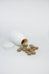medication for coronavirus. the coronavirus epidemic. propolis in tablets. brown pills on a white background