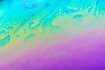 Fototapeta na wymiar abstract background soap bubble iridescent colors, sequins paint blue violet