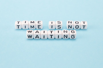 time is not waiting for you do it now - motivational phrase composed with cubes