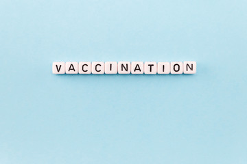 the word Vaccination on a blue background