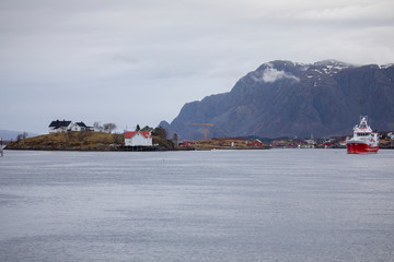 Red fishing boat / trawler passes through Brønnøysundet in Nordland county