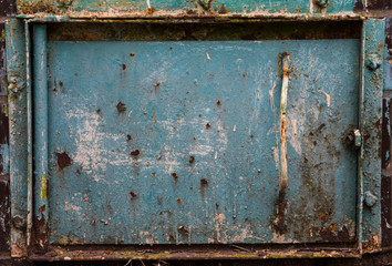 Old metal small door painted with blue paint