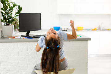 cheerfully cute girl children excited using computer learning schoolwork. kid enjoy e-learning in...