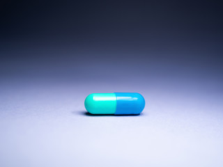 Pill capsule isolated. Macro close up. 
Medicine for the treatment of diseases. Vaccine and medicine pills. 
Health and care Concept. Blue Pill anti inflammatory painkiller.