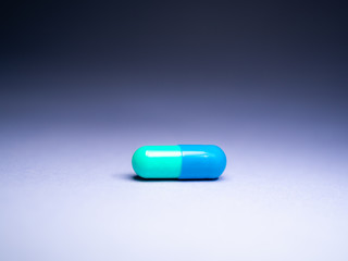 Pill capsule isolated. Macro close up. 
Medicine for the treatment of diseases. Vaccine and medicine pills. 
Health and care Concept. Blue Pill anti inflammatory painkiller.