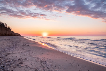 Fototapeta na wymiar Sea surf, waves, beautiful dawn sunrise at the Black sea, Odessa area, Lebedevka. Seascape.