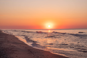 Sea surf, waves, beautiful dawn sunrise at the Black sea, Odessa area, Lebedevka. Seascape.