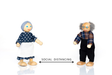 Miniature figures of grandparents. Social distancing in epidemic time concept.