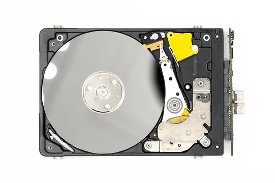 Disassambled Hard disk drive isolated on white background .