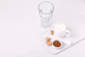 ingredients for dalgona coffee, milk and cane sugar. South Korean summer drink