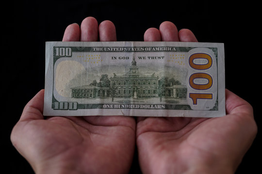 Hands Handling 100 Dollar Bill