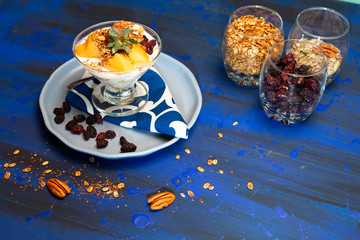 Melon pieces, on blue table with blue plate and seeds.
