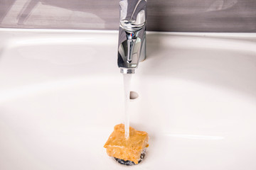 flowing weather on olive soap in the sink