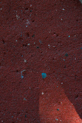 Old red concrete wall with light of the sun.