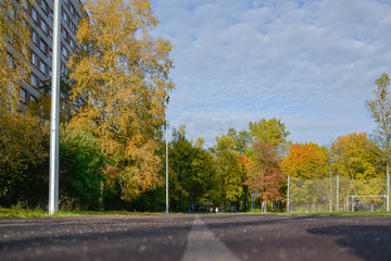 Obraz premium Saint Perersburg, Russia. September, 29, 2014. Racetrack treadmill at the school stadium surrounded by autumn plants