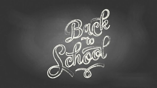 handwritten curly typography font design with the text back to school drawn with white chalk on a black chalkboard illuminated in some parts