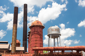Sloss Furnaces National Historic Landmark, Birmingham Alabama USA, water tower, furnaces and smoke stacks, blue sky with clouds - obrazy, fototapety, plakaty