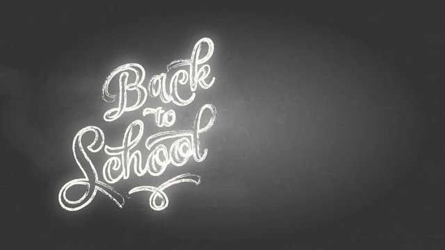 handwritten curly typography script design with the script back to school drawn with white chalk on a black chalkboard luminous in few segments