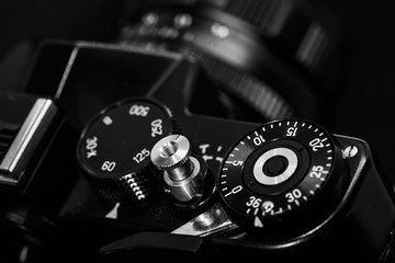 35mm camera in black and white on a dark background