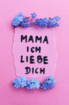 Piece Of Paper With Text I Love You Mama In German. Motherday Concept.