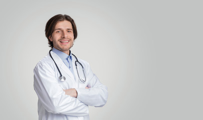 Portrait Of Smiling Medical Adviser Wearing White Coat And Stethoscope