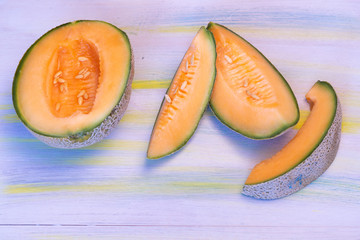 Melon on white table, with plate blue and white.