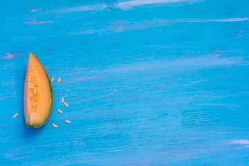 Melon on blue table, with plate blue and white.