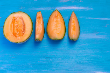 Melon on blue table, with plate blue and white.