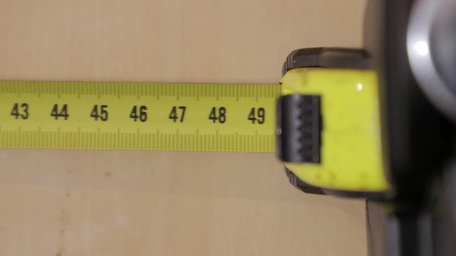 Using measuring tape to check sizes of furniture