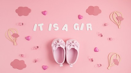 Cute newborn baby girl shoes with festive decoration over pink background. Baby shower, birthday, invitation or greeting card idea. Stop motion animation