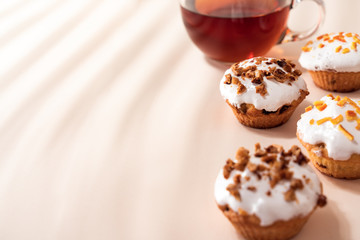 Dessert tea with Muffins on light table. Close up, Copy space.