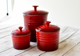 Red kitchen storage canisters for coffee, sugar, flour and other kitchen necessities for easy...