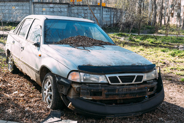 Abandoned old car wreck in the outdoors