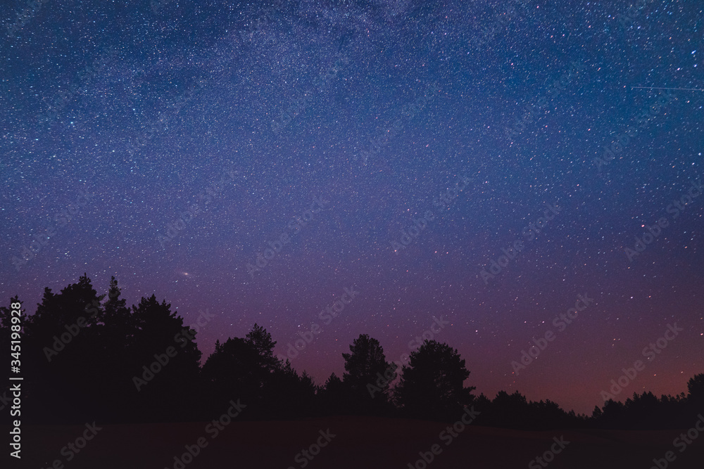Wall mural landscape with blue milky way. night sky with stars. beautiful milky way taken in ukraine during a c