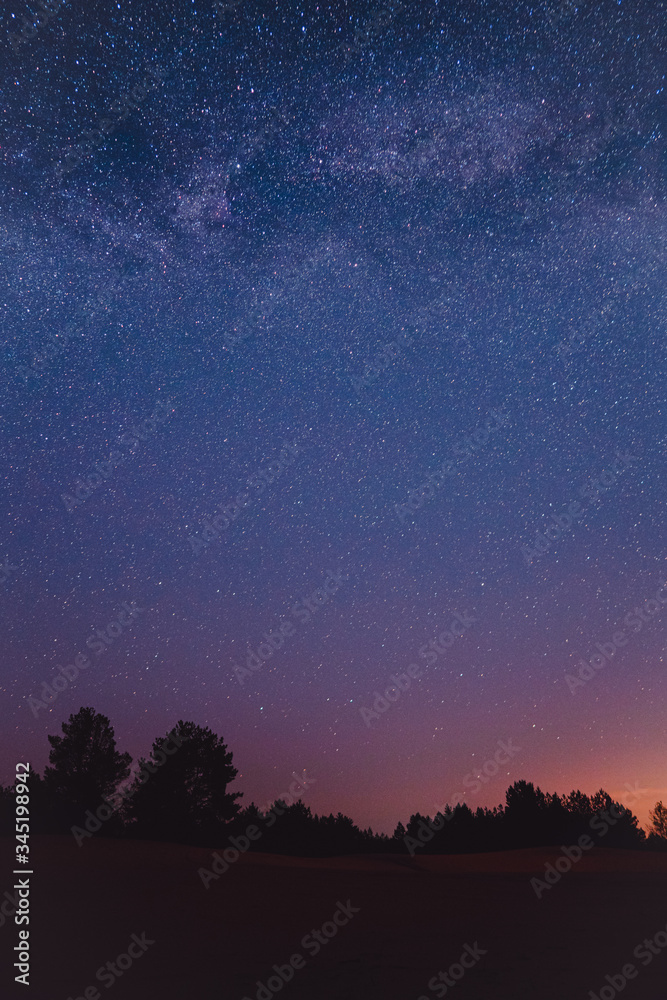 Wall mural landscape with blue milky way. night sky with stars. beautiful milky way taken in ukraine during a c